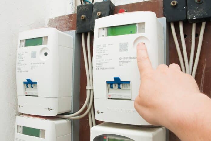 Man checks the consumption on the new e-distributione (enel) electricity meter