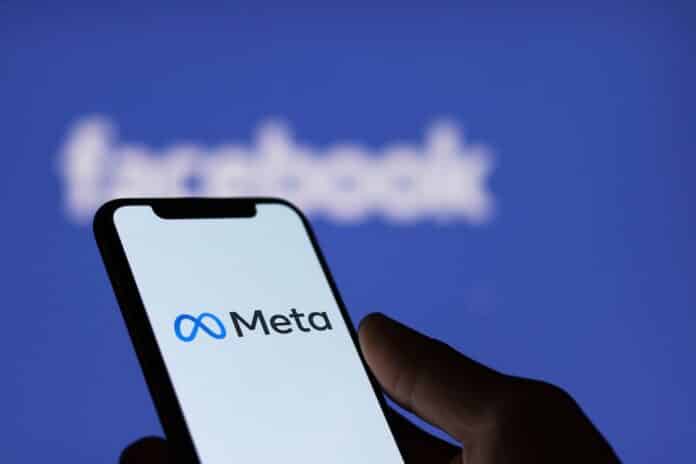 Meta logo on smartphone screen and Facebook logo background : Chiang Mai, Thailand, January 9, 2022 Ai
