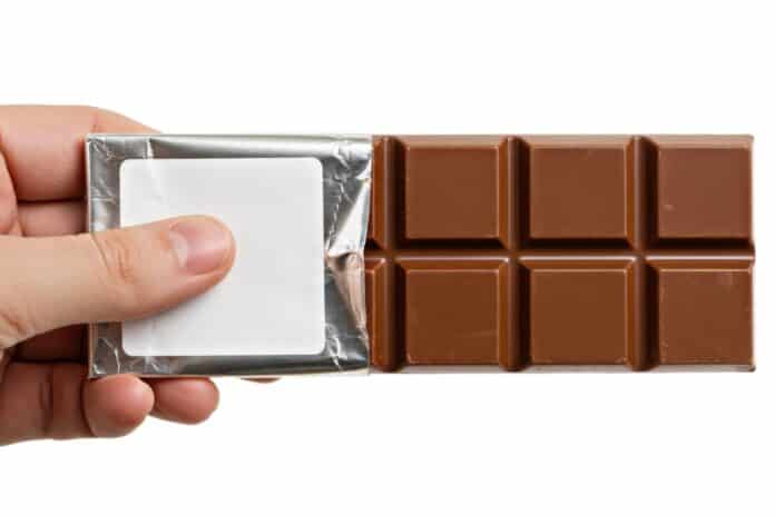 Close-up of driver undergoing sobriety test with breathalyzer device during daylight traffic stop shrinkflation