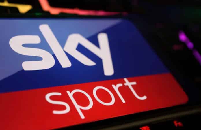 Viersen, Germany - May 1. 2024: Closeup of smartphone with logo lettering of Sky Sport channel streaming service on computer keyboard sky