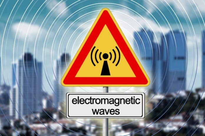 ALERT ABOUT ELECTROMAGNETIC POLLUTION EXPOSURE IN A MODERN CITY - Concept with base radio station for global communications services and electromagnetic emissions fields ONDE ELETTROMAGNETICHE