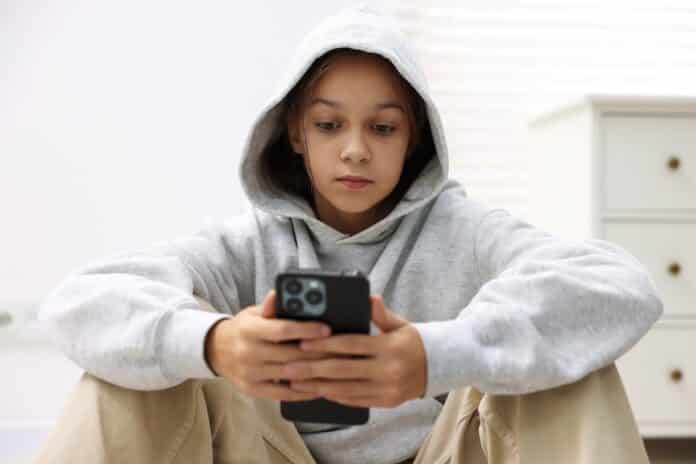 Cyber danger. Girl using phone at home social