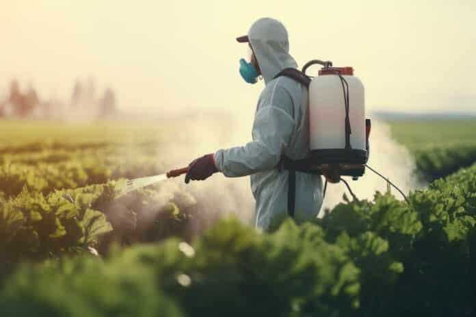 Pesticide and Fertilizer Application: "A farmer in protective gear spraying crops with a pesticide applicator. pesticidi omnibus