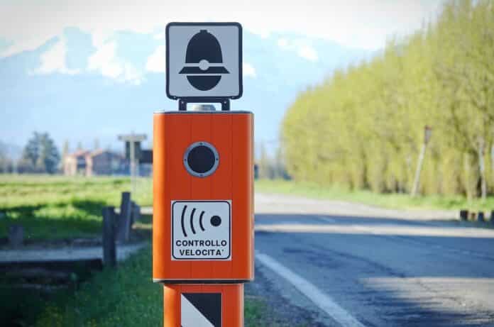 Traffic Enforcement Camera with TEXT that means electronic speed control in italian language and symbol of police autovelox