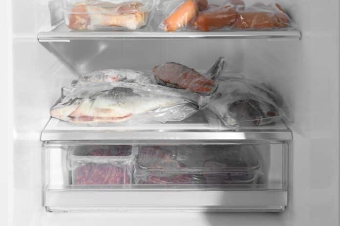 Different frozen meat and fish products in fridge PESCE BISFENOLO