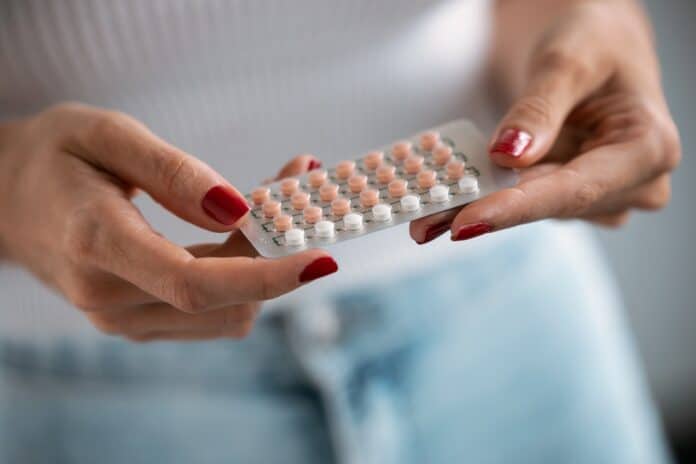 Woman holding a contraceptive pills. Concept of contraception methods. CONTRACCETTIVI