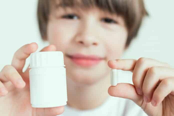 Medicine for child. Children whith pills and supplement in the bottle vitamins for better immunity. Child taking medicines pills. Medical concept. Nutrition, healthcare background PSICOFARMACI BAMBINI RAPPORTO OSMED