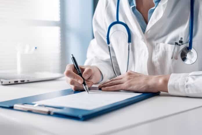 Doctor writing a medical prescription ticket