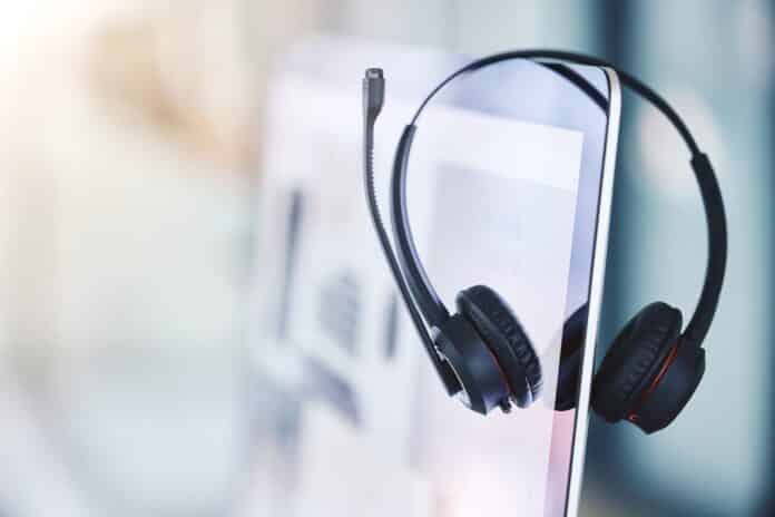 Headset, call center and computer for customer service in an empty office space. Crm, telemarketing and sales or technical support company with headphones and desktop pc for help desk consultation telemarketing