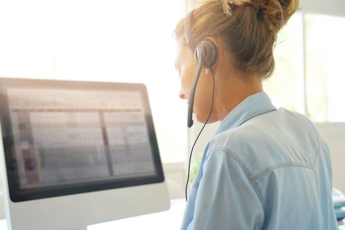 Customer service operator talking on phone in office telemarketing