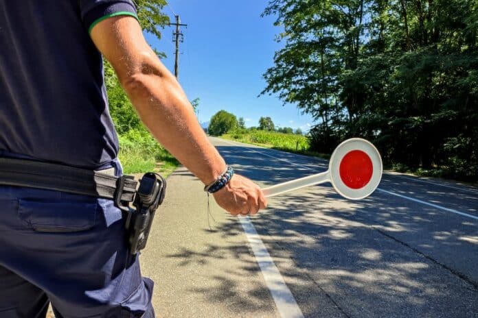 Policeman with a paddle close-up multe